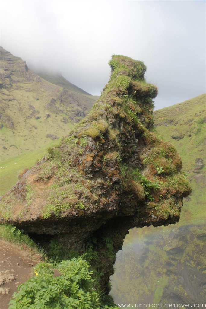 A weird face shaped rock at the top of the Skogafoss waterfall